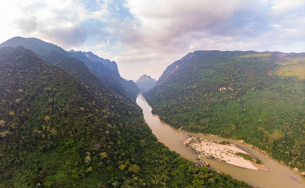 Aerial unique view from drone: Nam Ou river valley at Muang Ngoi Laos, sunset colorful sky, dramatic mountain landscape, travel destination in South East Asia