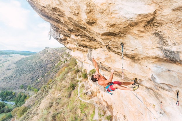 Aerial view of an adult man climbing a rock formation