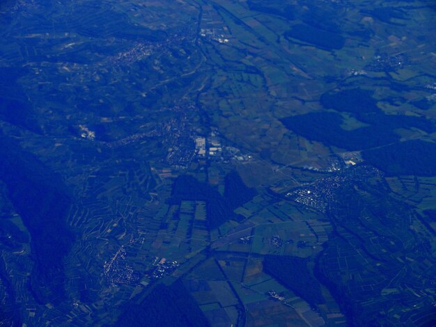 Aerial view of agricultural landscape against blue sky
