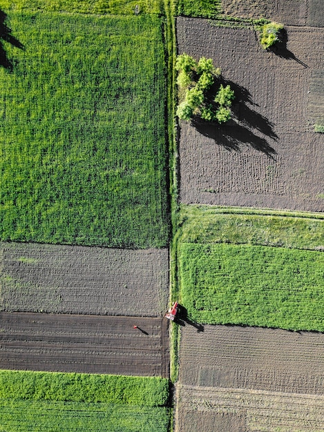 Aerial view agricultural work in the field, a tractor in the field.