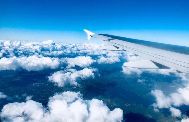 Aerial view of aircraft wing over clouds