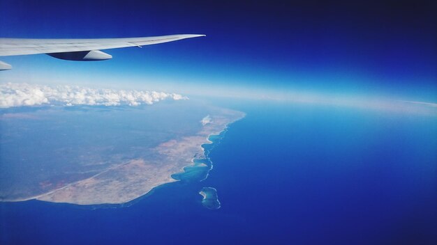 Aerial view of aircraft wing over sea