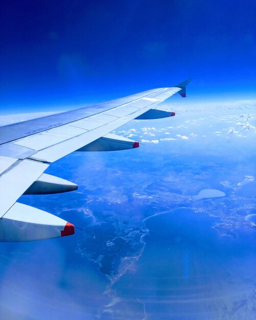 Aerial view of airplane flying in sky