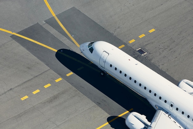 Aerial view of airport airplane taxiing to runway before take off