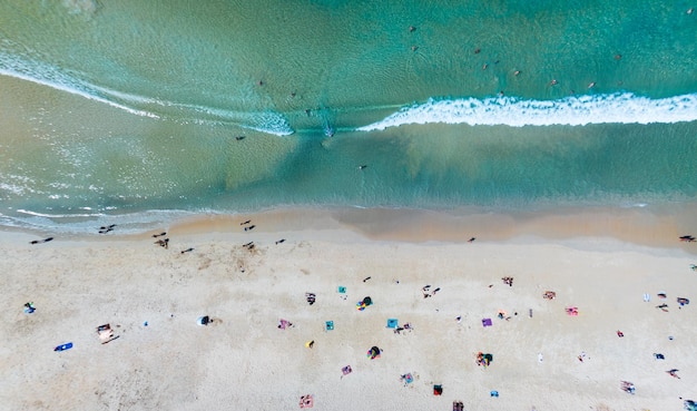 Aerial View Amazing beach with travel people relaxation on the beachBeautiful sea in summer season at Phuket island ThailandTravel people on beachBeach during summer with many resting people