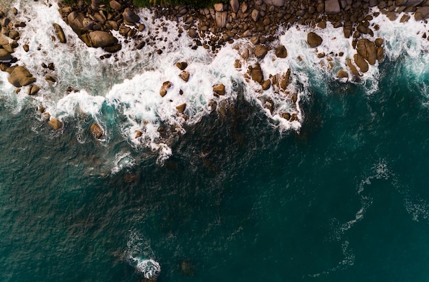 Aerial view of Amazing seashore at Phuket Thailand beautiful wave crashing on seacoast Top view sea in summer season