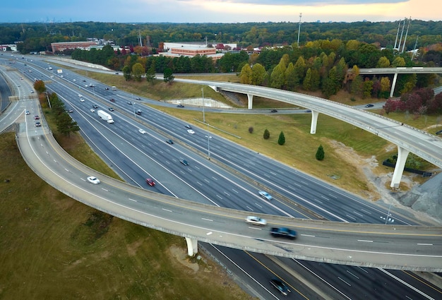 Aerial view of american freeway intersection with fast moving cars and trucks USA transportation infrastructure concept