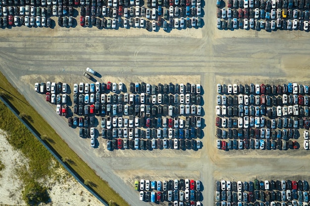 Aerial view of auction reseller company big parking lot with parked cars ready for remarketing services Sales of secondhand vehicles