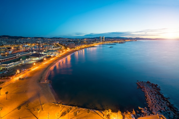 Aerial view of Barcelona Beach in summer night along seaside in Barcelona, Spain. 