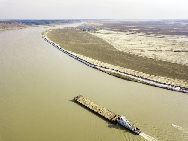 Aerial view of barge on Tom river, early spring in Siberia, Tomsk, Russia.