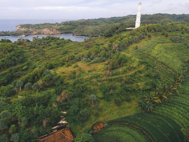 Aerial view of Baron beach in Yogyakarta Indonesia with lighthouse and traditional boats