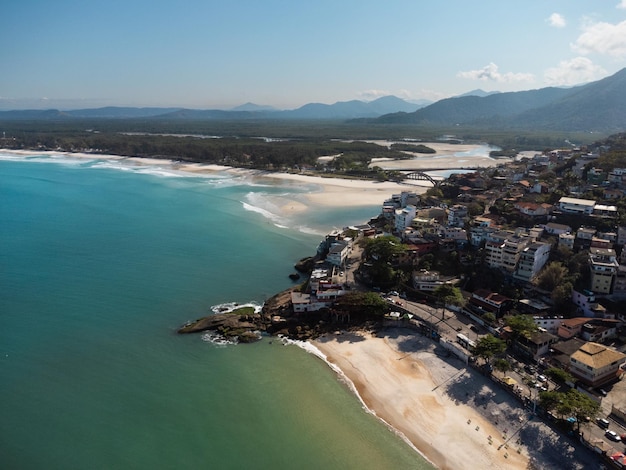 Aerial view of Barra de Guaratiba west zone of Rio de Janeiro Brazil Next to Marambaia beach Big hills around Sunny day at dawn Beach with clear water Barra de Guaratiba beach Drone photo