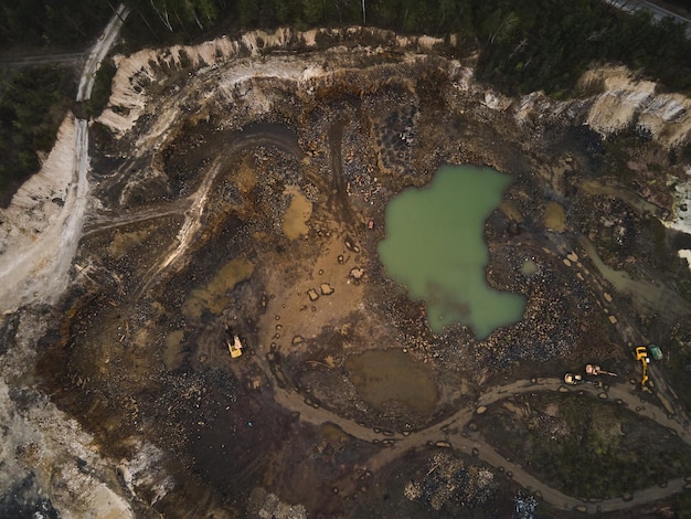 Photo aerial view basalt quarry of open pit with bulldozer and car