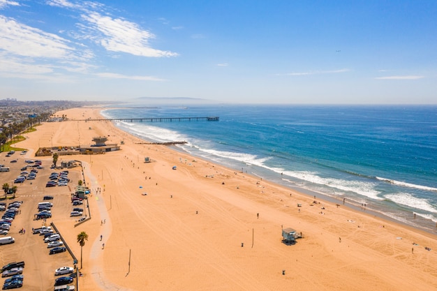 Aerial view of a beach seashore with the blue sea on the right side