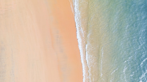 Aerial view of Beach with shade emerald blue water and wave foam on tropical sea 