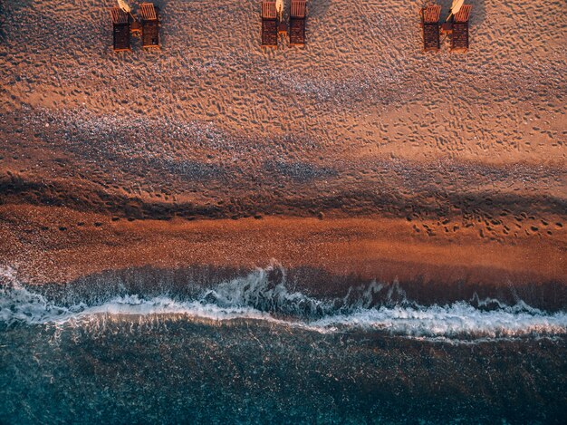 Aerial view of the beach with sun loungers near the island of sveti stefan in montenegro