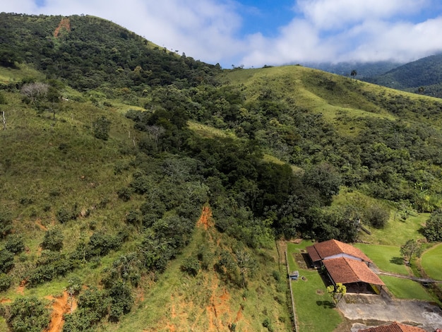 Aerial view of beautiful forest full of nature and pasture fields in Tremembe in Vale da Paraiba in Sao Paulo Mountains and hills in sunny day Lots of green and tropical vegetation Drone