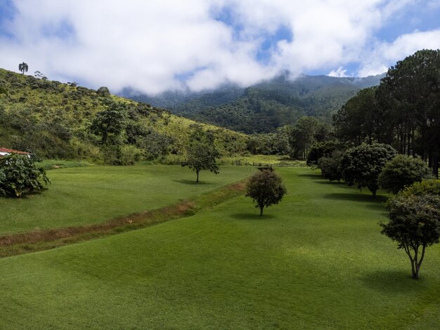 Aerial view of beautiful forest full of nature and pasture fields in Tremembe in Vale da Paraiba in Sao Paulo Mountains and hills in sunny day Lots of green and tropical vegetation Drone