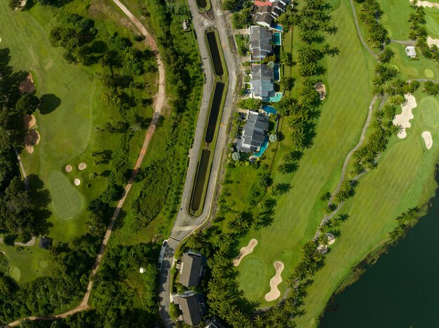 Aerial view of beautiful green golf field fairway and putting greenTop view image for sport background and travel nature background Amazing green nature view