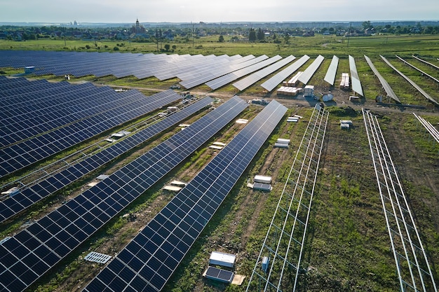 Aerial view of big electric power plant under construction with
many rows of solar panels on metal frame for producing clean
electrical energy development of renewable electricity sources