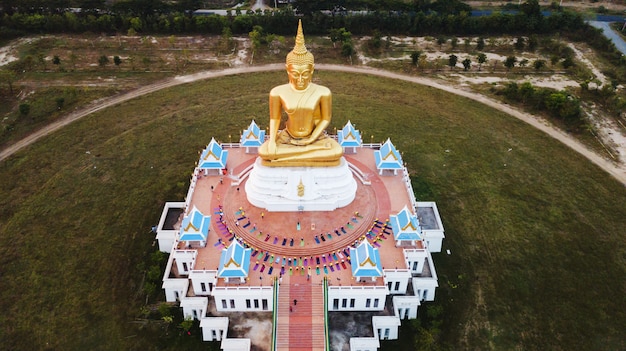 Aerial view of Big Golden buddha statue at sun rise, countryside of Thailand