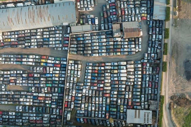 Aerial view of big parking lot of junkyard with rows of discarded broken cars Recycling of old vehicles