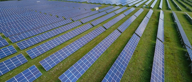 Aerial view of big sustainable electric power plant with many rows of solar photovoltaic panels for producing clean electrical energy Renewable electricity with zero emission concept