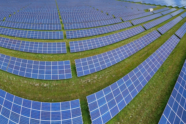 Aerial view of big sustainable electric power plant with many rows of solar photovoltaic panels for producing clean electrical energy Renewable electricity with zero emission concept