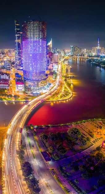 Aerial view of bitexco and ifc one saigon tower buildings roads\
thu thiem 2 bridge and saigon river in ho chi minh city far away is\
landmark 81 skyscraper travel concept