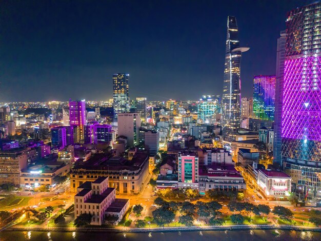 Aerial view of bitexco and ifc one saigon tower buildings roads\
thu thiem 2 bridge and saigon river in ho chi minh city far away is\
landmark 81 skyscraper travel concept