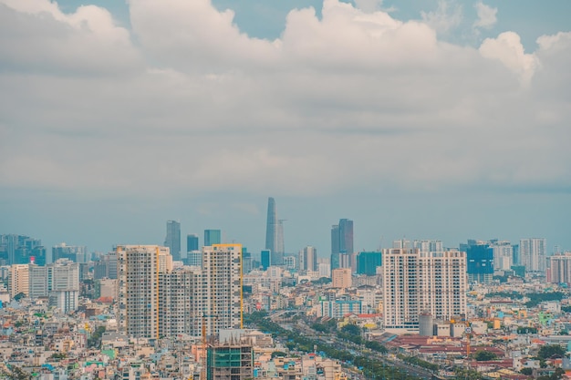 Aerial view of Bitexco Tower buildings roads Vo Van Kiet road in Ho Chi Minh city Far away is Landmark 81 skyscraper Travel concept