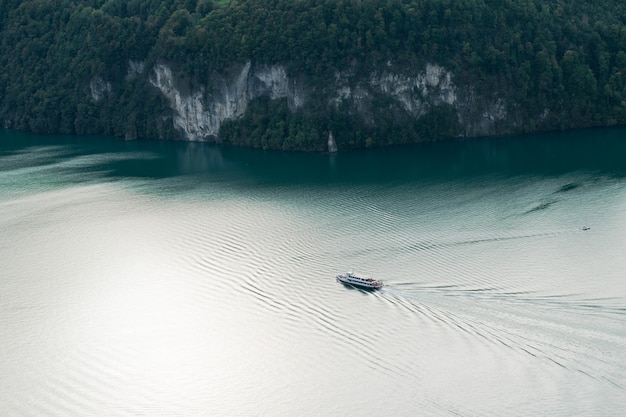 Aerial view of a boat cruising on a alpine lake in Switzerland