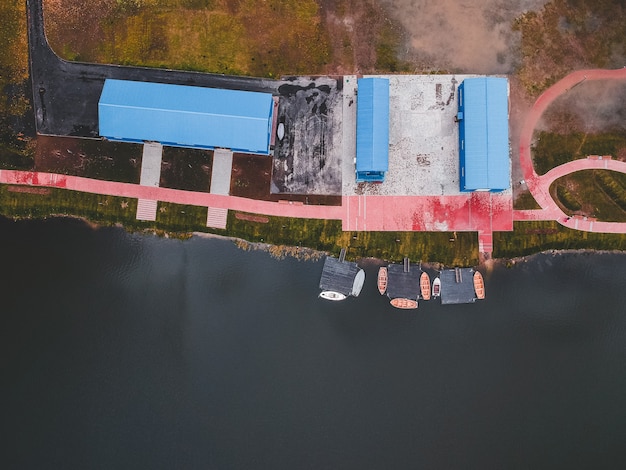 Aerial view to the boathouse. Rowing training boats moored to the pier. Russia, St. Petersburg.