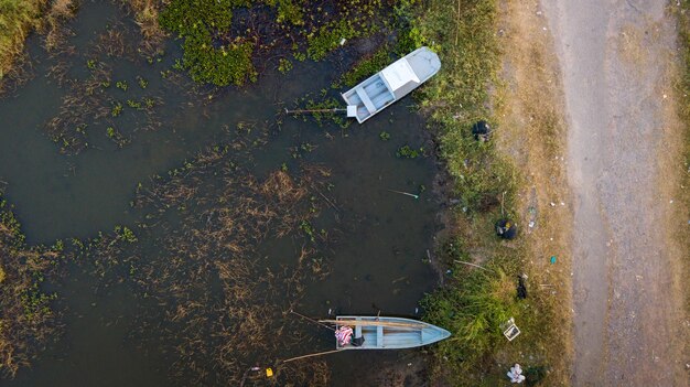 Aerial view of boats parked near pier on the lake