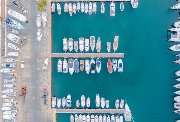 Aerial view of the boats and yachts in a Mediterranean harbor with turquoise waters