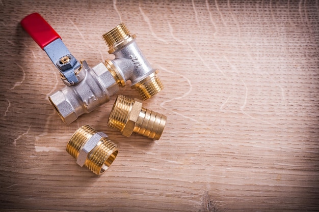 Aerial View Brass Pipe Connectors On Wooden Board