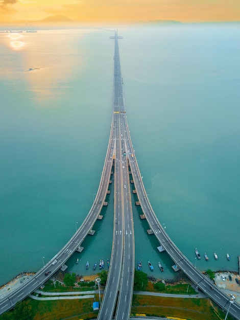 Aerial view of bridge over sea during sunset