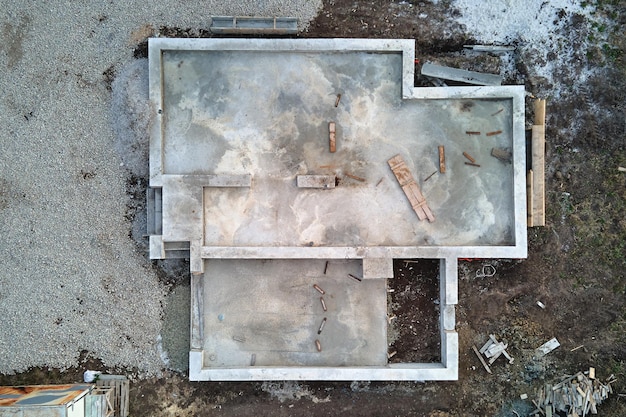 Aerial view of building works of new house concrete foundation on construction site