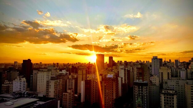 Aerial view of buildings against sky during sunset