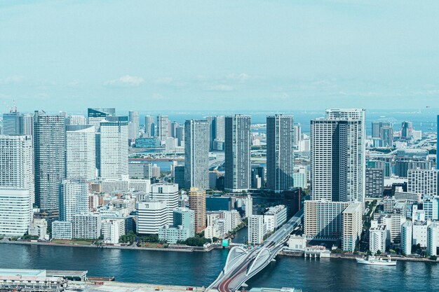 Aerial view of buildings in city against sky