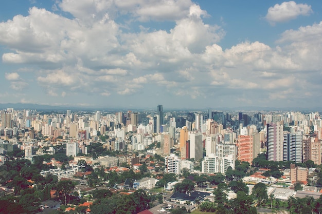 Aerial view of buildings in city against sky