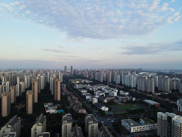 Aerial view of buildings in city against sky