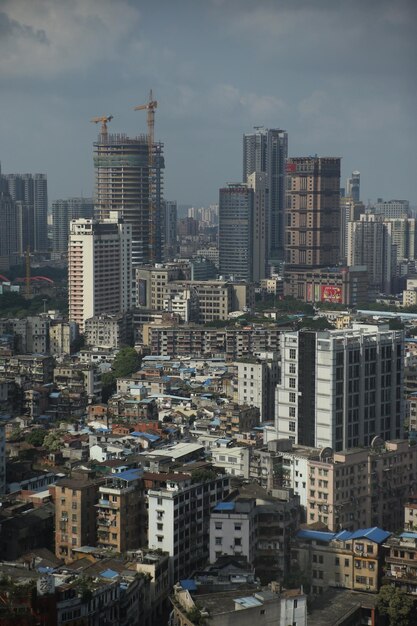 Aerial view of buildings in city against sky