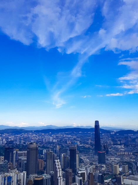 Aerial view of buildings in city against sky