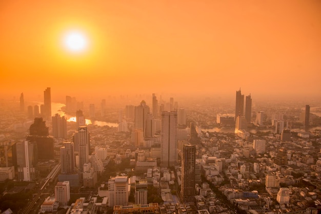 Aerial view of buildings in city during sunset