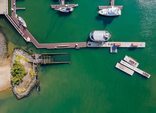 Aerial view by small group of sail boats in a marina sunny summer day