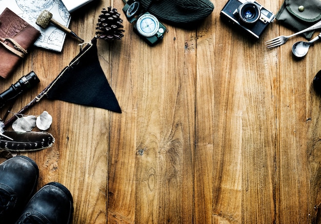 Aerial view of camping stuff on wooden background