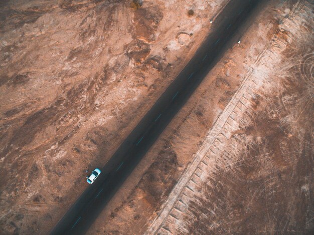 Aerial view of car park on road by barren landscape