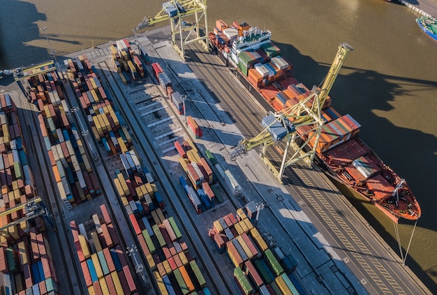 Aerial view of cargo ship unloading in container terminal