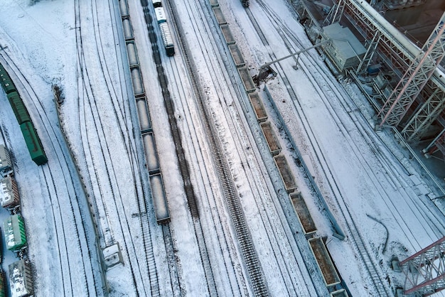 Aerial view of cargo train cars loaded with construction goods\
at mining factory railway transportation of industrial production\
raw materials